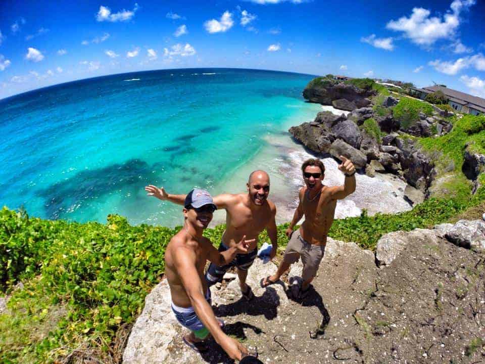 waving to camera at the beach in Barbados Caribbean