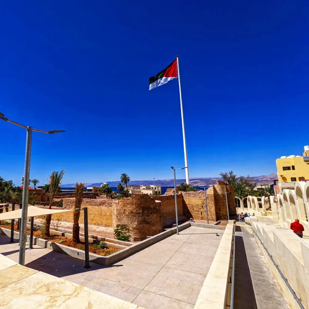 Aqaba is a Jordanian port city on the Red Sea's Gulf of Aqaba .big Jordanian flag
