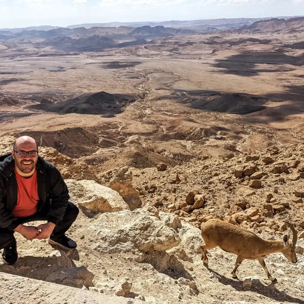 Isaac and an Ibex hanging on a cliff Mitzpe Ramon Israel