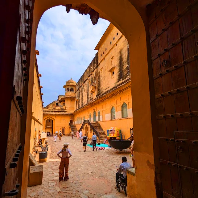 The Amber Fort is a magnificent palace complex located on a hilltop overlooking the city Jaipur India, girl looking